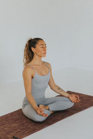 Woman unrolling a yoga mat
